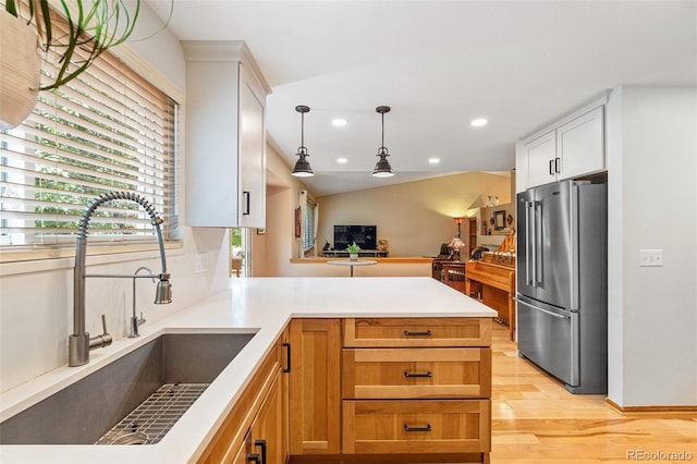 11313 Haswell Dr, Parker, CO 80134 - kitchen featuring freestanding refrigerator, recessed lighting, light wood finished floors, hanging light fixtures, and a peninsula