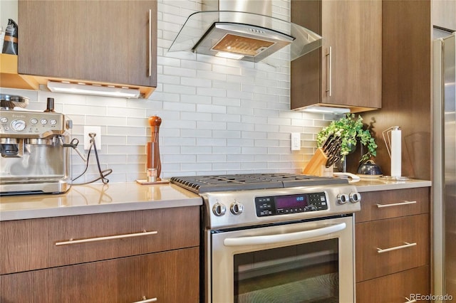 kitchen featuring backsplash, ventilation hood, and appliances with stainless steel finishes