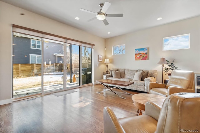 living room featuring ceiling fan and light wood-type flooring