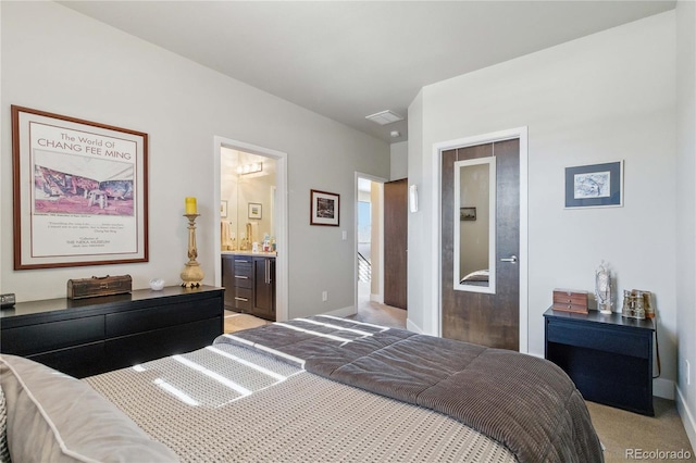 carpeted bedroom featuring ensuite bath