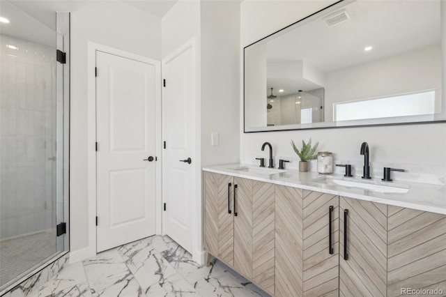 bathroom with vanity and a shower with door