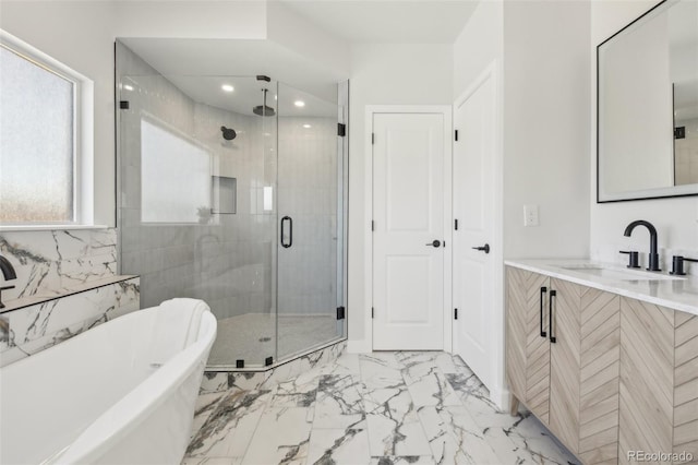 bathroom with vanity and shower with separate bathtub