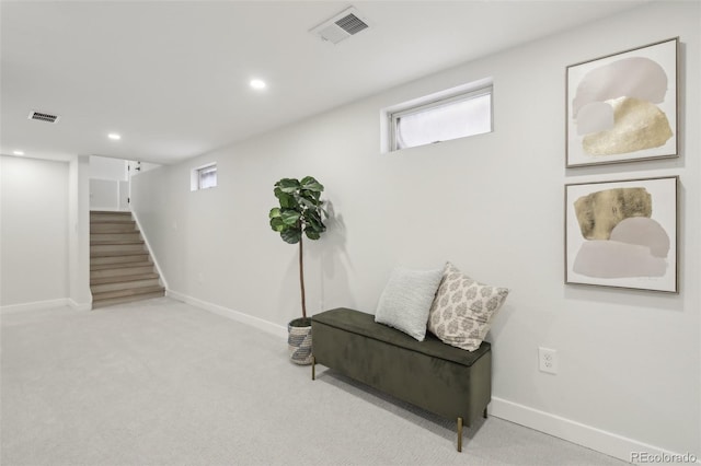 living area with light carpet and plenty of natural light