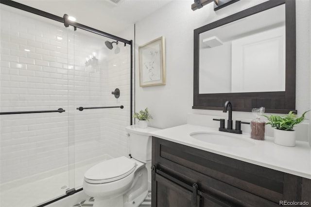 bathroom with vanity, toilet, and an enclosed shower