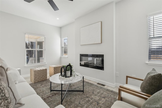 living room with wood-type flooring and ceiling fan