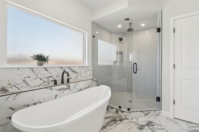 bathroom featuring shower with separate bathtub and a wealth of natural light