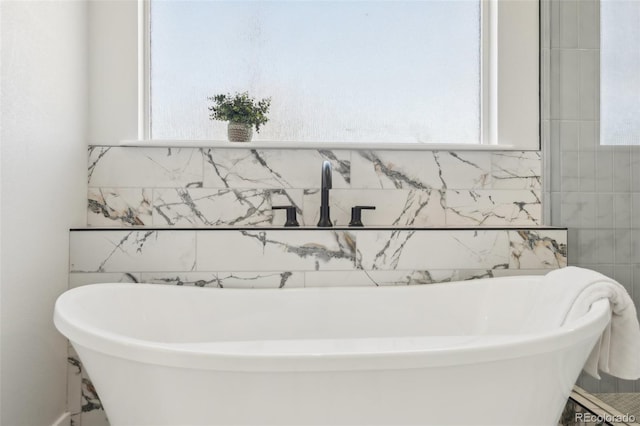 bathroom with a bathing tub and plenty of natural light