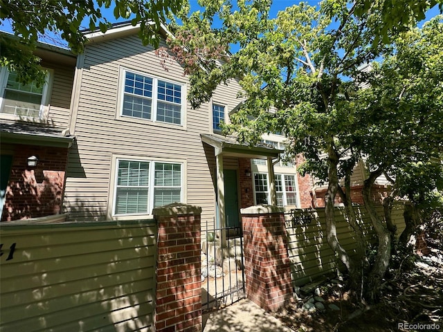 10035 E Mexico Ave, Aurora, CO 80247 - view of front of property with brick siding and a gate