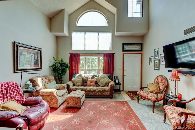 10035 E Mexico Ave, Aurora, CO 80247 - living area featuring high vaulted ceiling, carpet floors, and plenty of natural light