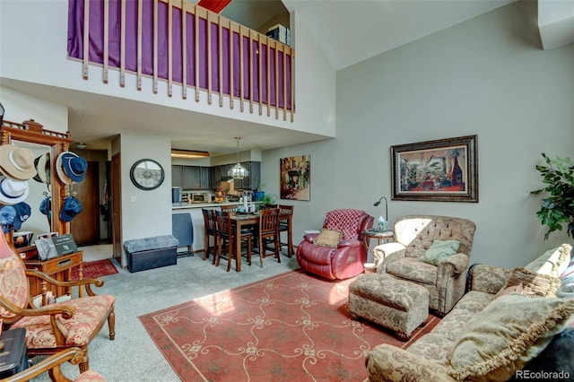 10035 E Mexico Ave, Aurora, CO 80247 - living area with carpet flooring, high vaulted ceiling, and a chandelier