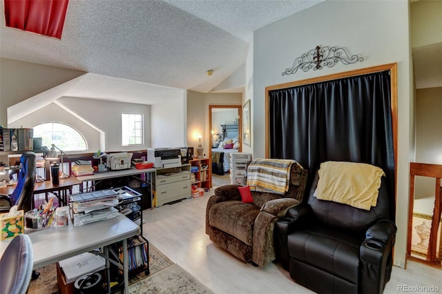 10035 E Mexico Ave, Aurora, CO 80247 - living area with lofted ceiling, a textured ceiling, light wood-style floors, and an office area