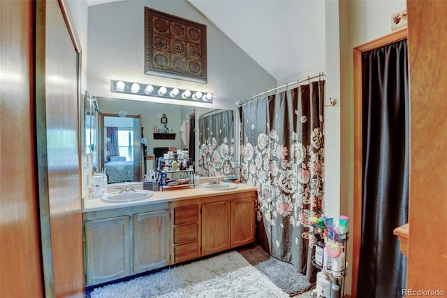 10035 E Mexico Ave, Aurora, CO 80247 - full bath featuring lofted ceiling, double vanity, and a shower with curtain