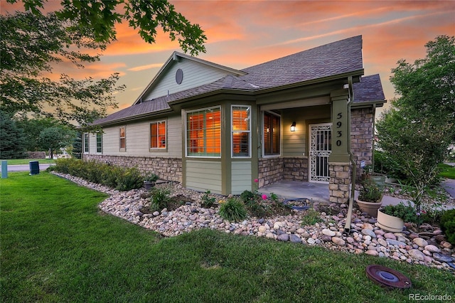 view of front of house featuring a yard and a patio area