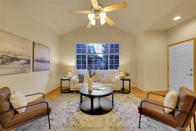 living area with vaulted ceiling, ceiling fan, and light hardwood / wood-style flooring