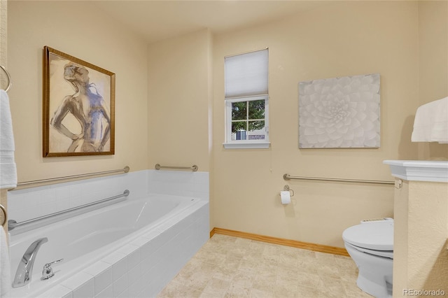 bathroom with tiled tub and toilet