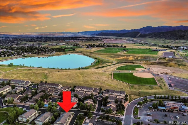 aerial view at dusk with a water and mountain view