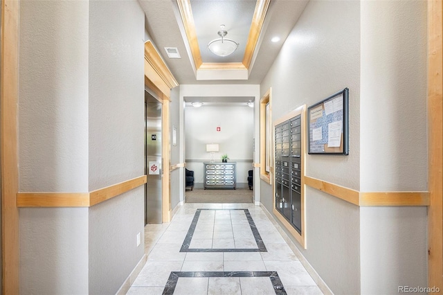 301 Inverness Way S Unit 202, Englewood, CO 80112 - corridor with inlaid floor details, a tray ceiling, baseboards, mail area, and tile patterned flooring