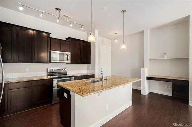 301 Inverness Way S Unit 202, Englewood, CO 80112 - kitchen with appliances with stainless steel finishes, a sink, light stone countertops, dark wood-style floors, and a center island with sink