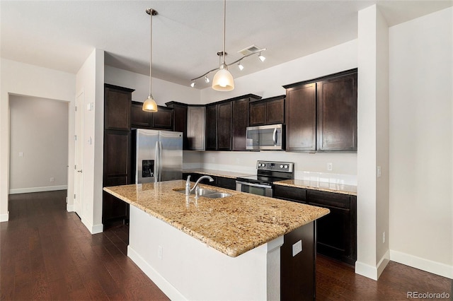 301 Inverness Way S Unit 202, Englewood, CO 80112 - kitchen with stainless steel appliances, a sink, light stone countertops, a kitchen island with sink, and dark brown cabinetry