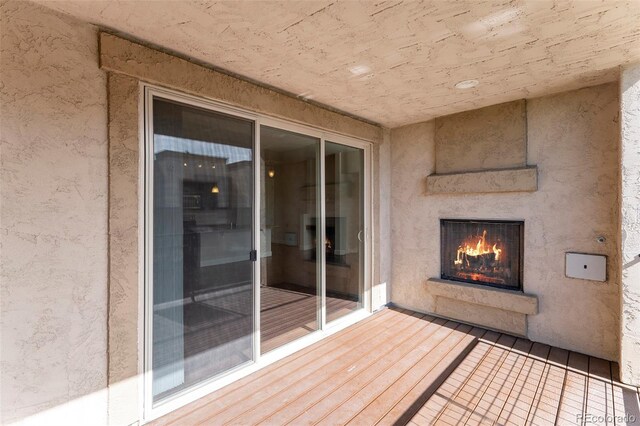 301 Inverness Way S Unit 202, Englewood, CO 80112 - wooden deck featuring a warm lit fireplace