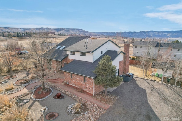 birds eye view of property with a mountain view