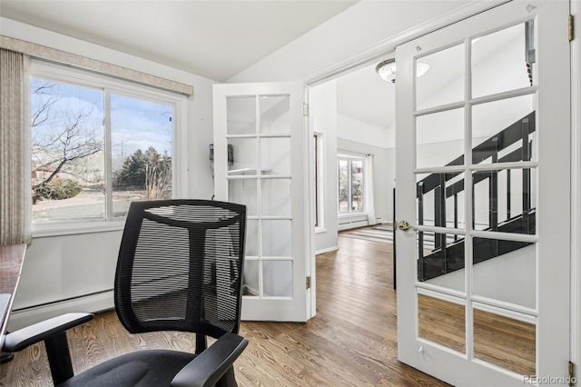 office space with vaulted ceiling and wood finished floors