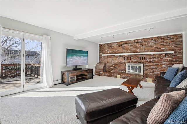 living area featuring carpet, rail lighting, baseboard heating, a brick fireplace, and brick wall