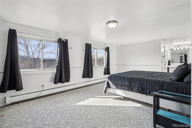 bedroom featuring a baseboard heating unit and carpet flooring