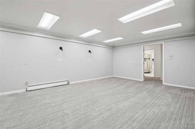 below grade area with carpet floors, a baseboard radiator, and baseboards