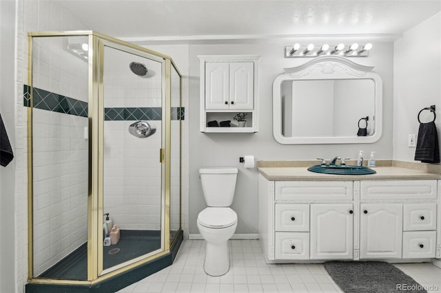 bathroom featuring baseboards, toilet, tile patterned flooring, vanity, and a shower stall