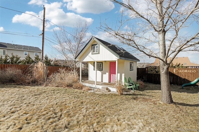 view of outbuilding featuring fence and an outbuilding