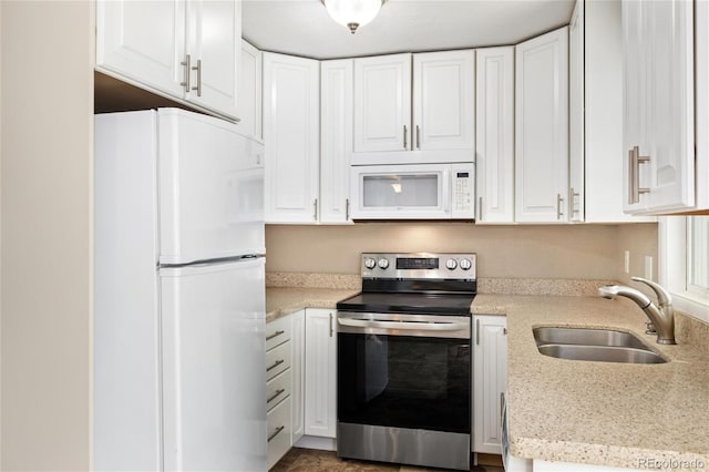 5142 S Pennsylvania St, Littleton, CO 80121 - kitchen with white appliances, a sink, and white cabinets