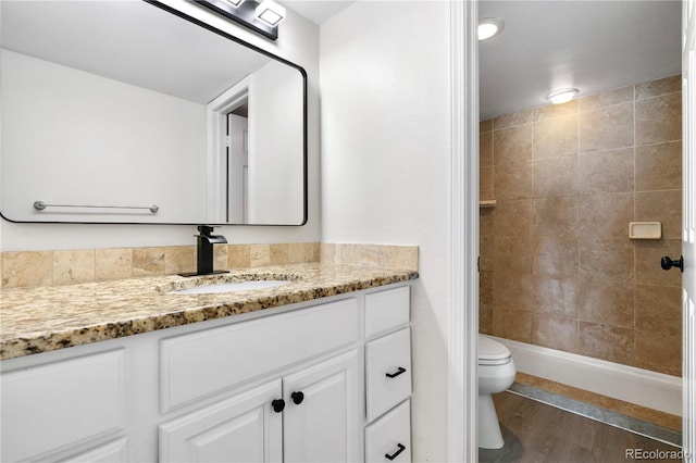 1732 S Trenton Unit 9, Denver, CO 80231 - full bath with vanity, tiled shower, and wood finished floors
