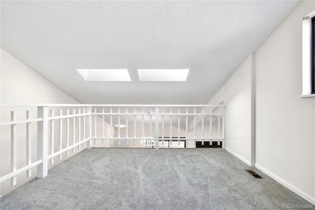 1732 S Trenton Unit 9, Denver, CO 80231 - bonus room featuring a skylight, carpet, and a textured ceiling