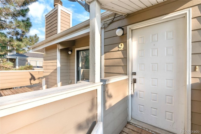 1732 S Trenton Unit 9, Denver, CO 80231 - view of exterior entry with a chimney