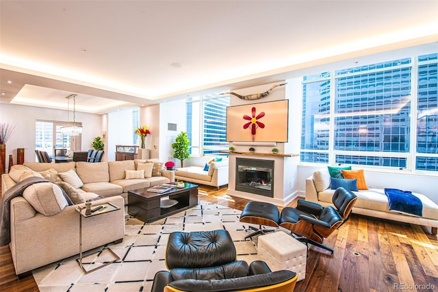 living room with a notable chandelier and hardwood / wood-style floors