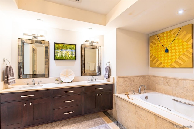 bathroom featuring a relaxing tiled tub and double vanity