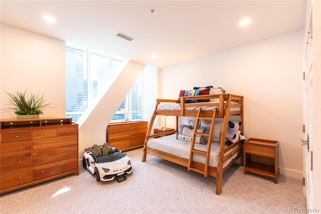 bedroom featuring light carpet