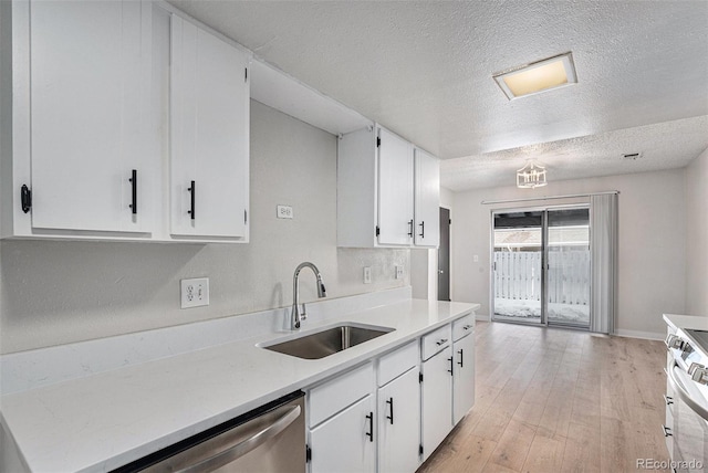 kitchen featuring sink, range, light hardwood / wood-style floors, and white cabinets