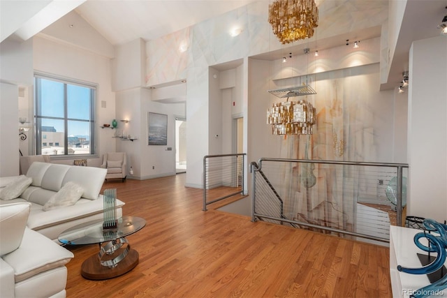 180 N Cook St Unit 509, Denver, CO 80206 - living area with high vaulted ceiling, a chandelier, and wood finished floors