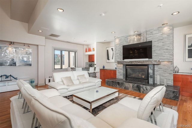 180 N Cook St Unit 509, Denver, CO 80206 - living room with wood finished floors, a tile fireplace, and recessed lighting