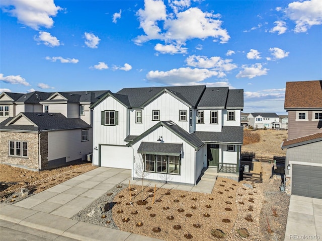 modern inspired farmhouse featuring a garage, a shingled roof, concrete driveway, a residential view, and board and batten siding