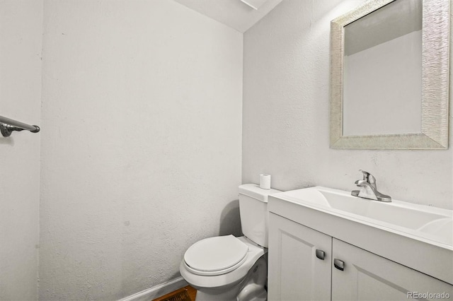 10349 W Fair Ave Unit A, Littleton, CO 80127 - bathroom with vanity, toilet, baseboards, and a textured wall