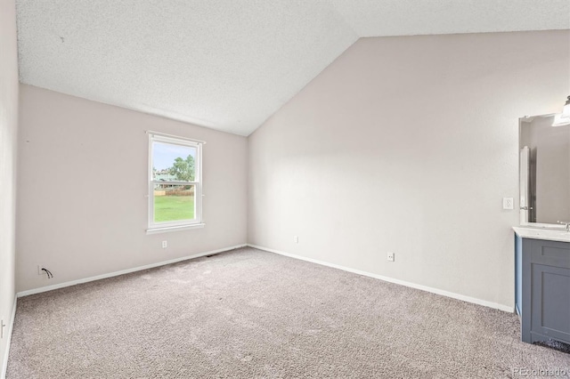 10349 W Fair Ave Unit A, Littleton, CO 80127 - carpeted spare room featuring vaulted ceiling, baseboards, and a textured ceiling