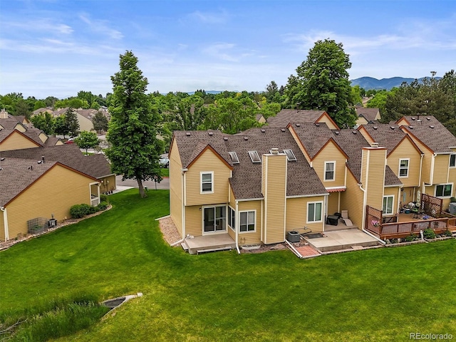 10349 W Fair Ave Unit A, Littleton, CO 80127 - back of property featuring a patio area, a chimney, a yard, and a residential view