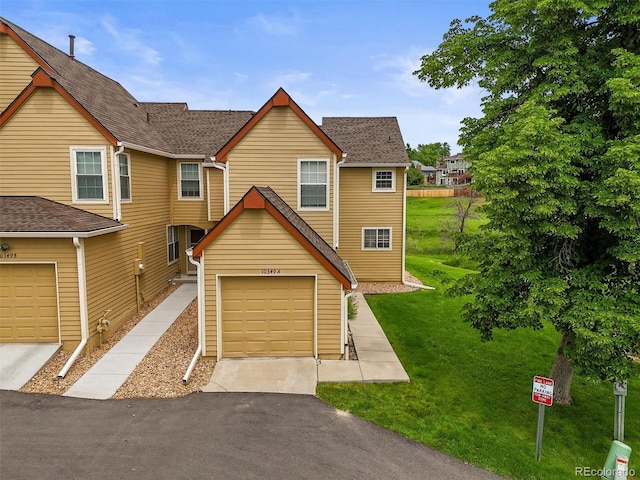 10349 W Fair Ave Unit A, Littleton, CO 80127 - view of front of property featuring a front yard, a garage, and driveway