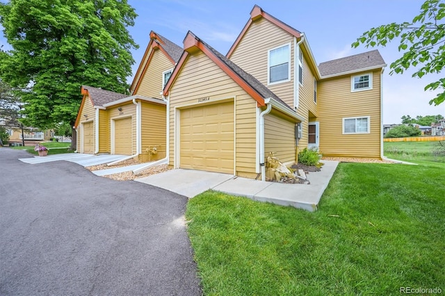 10349 W Fair Ave Unit A, Littleton, CO 80127 - traditional home featuring a front yard, driveway, and a shingled roof