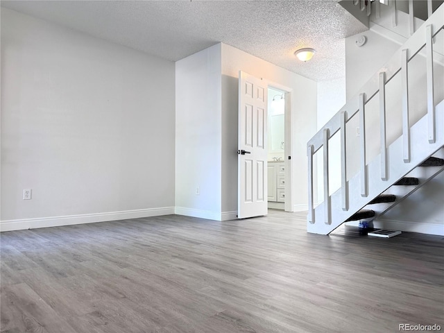 interior space featuring wood-type flooring and a textured ceiling