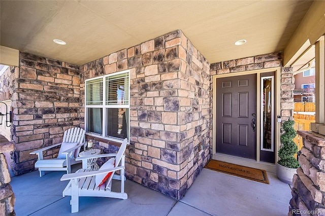 3838 Brush Rd, Castle Rock, CO 80108 - doorway to property with stone siding and covered porch