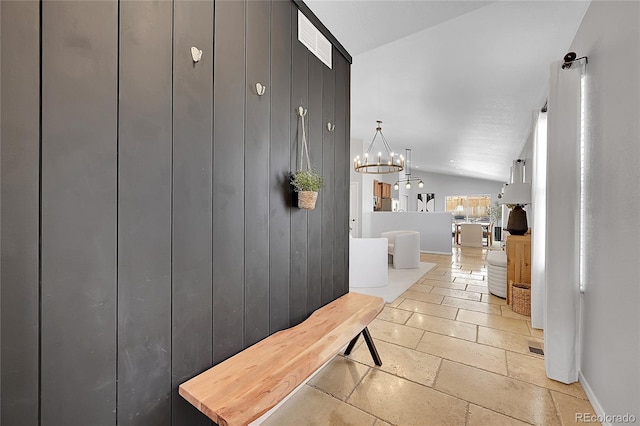 3838 Brush Rd, Castle Rock, CO 80108 - mudroom featuring lofted ceiling, a chandelier, stone tile flooring, and baseboards